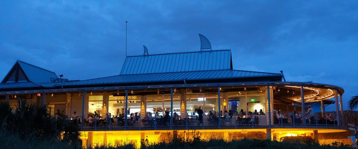 Waterfront restaurant at dusk protected by a lightning protection system