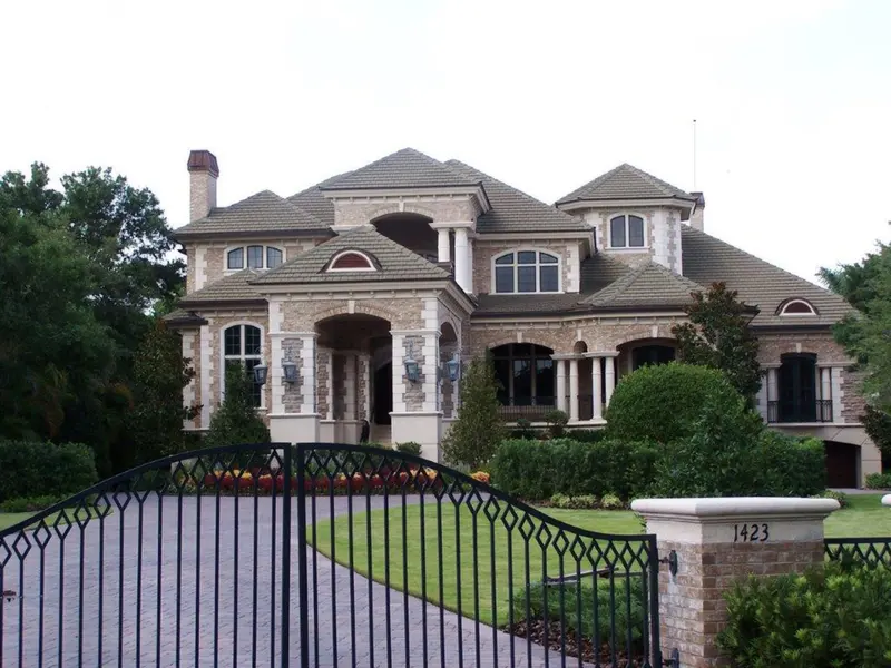 Wide view of a sprawling tile-roofed home and grounds covered by a single terminal